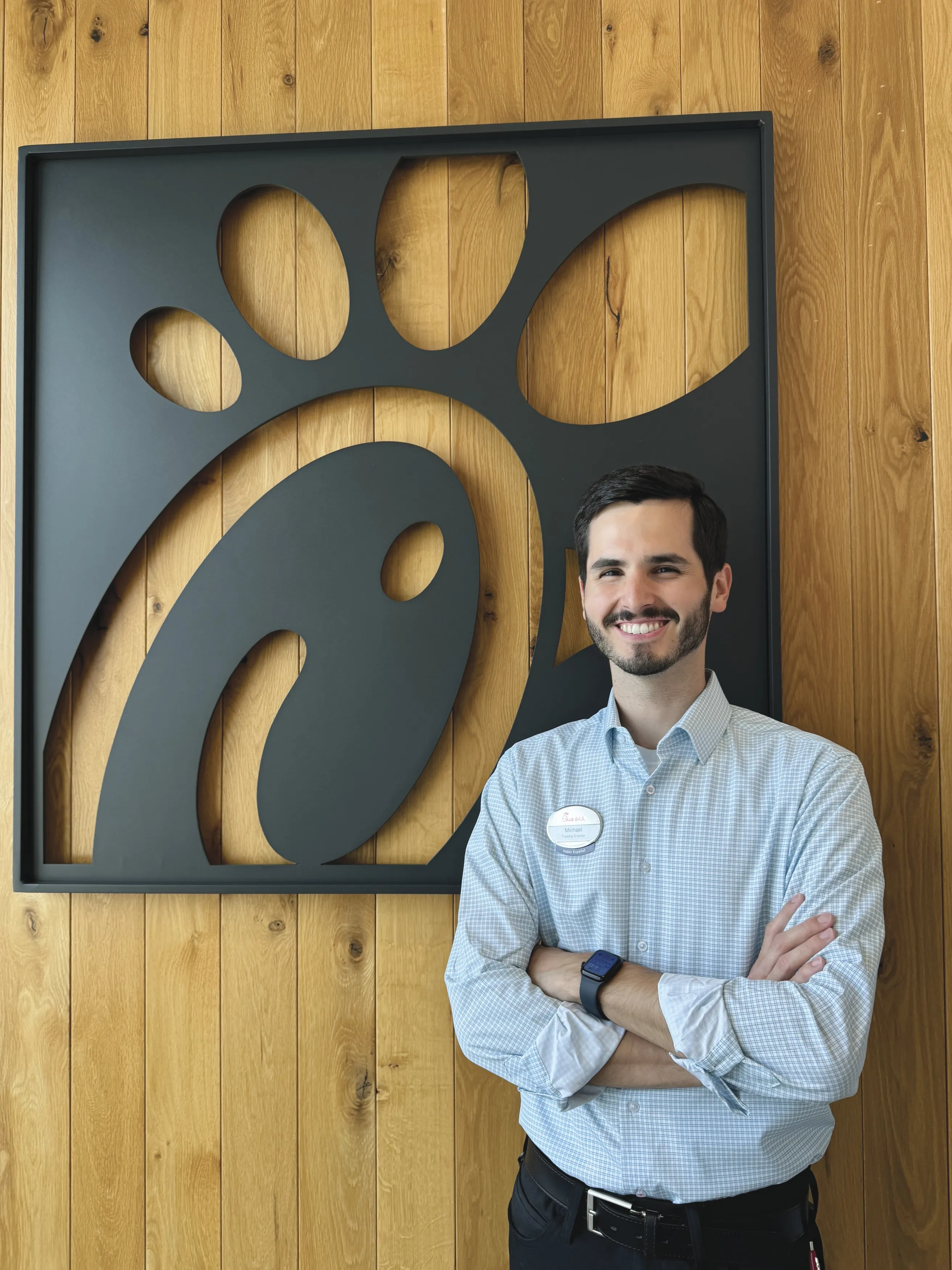 Michael Smith in front of chic-fil-a sign